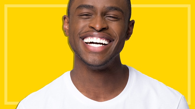 man with white teeth at home teeth whitening